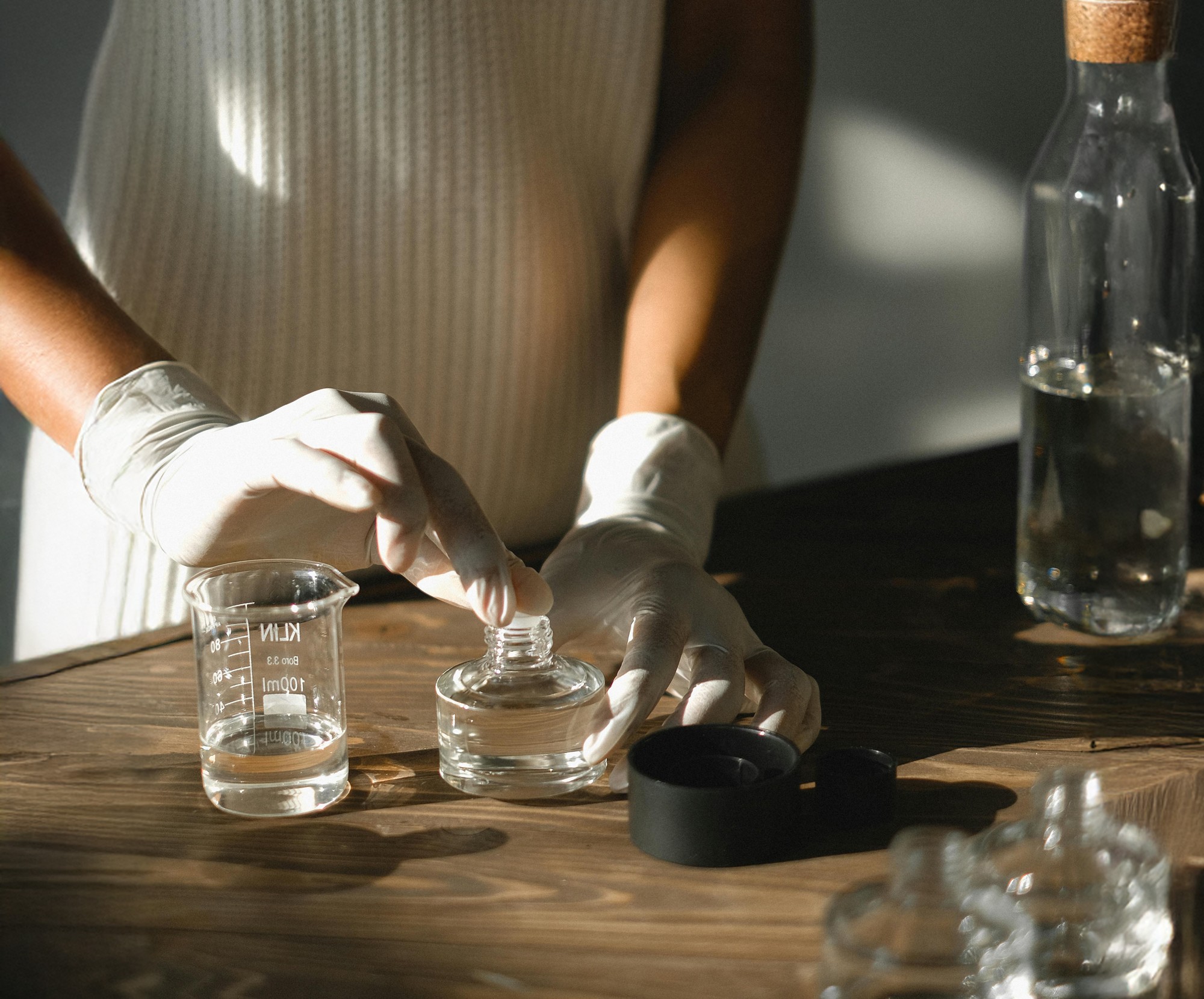 Two women sitting at a modern table talking with a city view behind them.